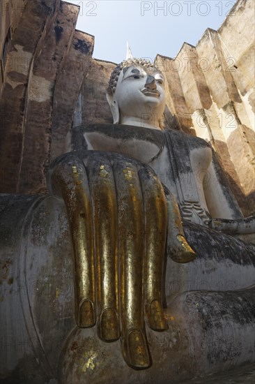 Gold-plated hand of the Seated Buddha statue of Phra Achana in Wat Si Chum Temple