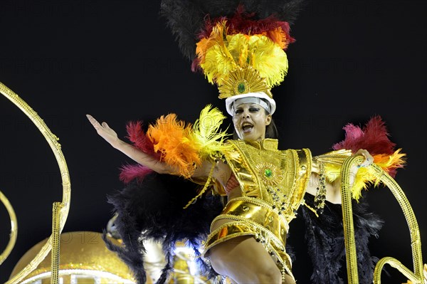 Dancer on a float in a colourful costume
