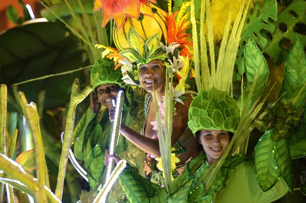Dancers in colourful costumes on floats