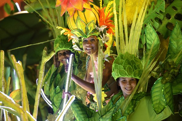 Dancers in colourful costumes on floats