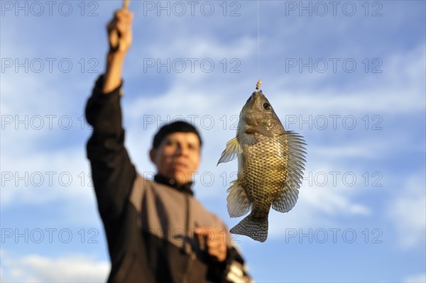 Indigenous man with a fish on the hook