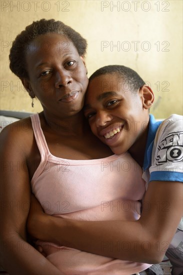 Boy hugging his mother in the slums