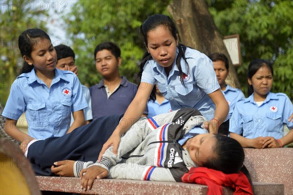 Young woman positioning a patient in the recovery position