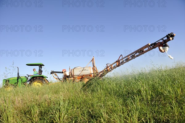 Spraying of pesticides on a field in a Mennonite community