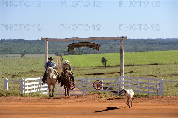 Two men riding horses