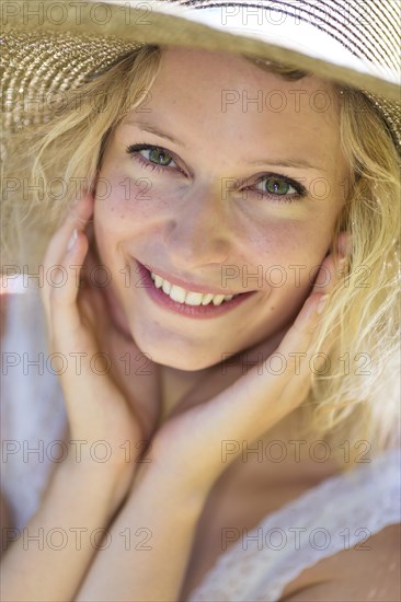 Smiling young woman with summer hat