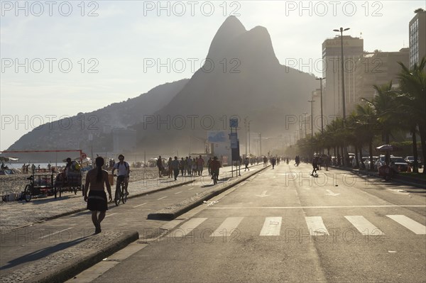 People walking along the sidewalk at Ipanema Beach