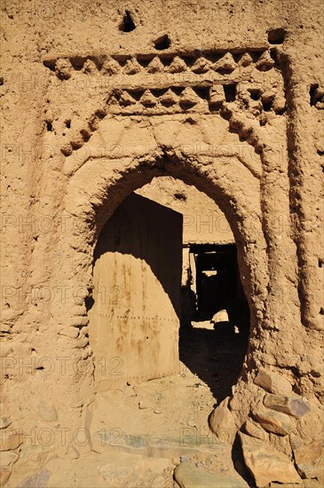 Clay stucco of a decaying entrance gate in the Kasbah Tamnougalt near Agdz