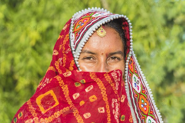 Veiled Ahir woman in traditional colorful with headgear