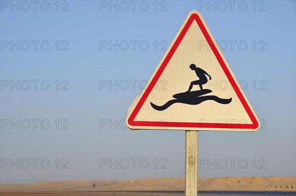 Road sign 'Caution Surfers' at the Rio de Oro Bay