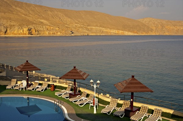 View of the coast of the Musandram Peninsula from the swimming pool area at the Golden Tulip Resort Hotel