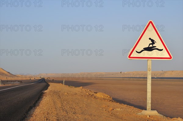 Road sign 'Caution Surfers' at the Rio de Oro Bay