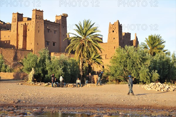 Mud-brick building or Tighremts and date palm trees (Phoenix dactylifera) of the fortified city or ksar Ait Ben Haddou