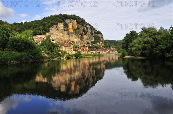 The village of La Roque-Gageac reflected in the water of the Dordogne river