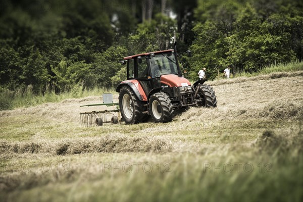 Tractor turning hay