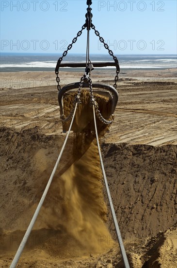 Excavator bucket of a dragline excavator transporting slag in a diamond mine