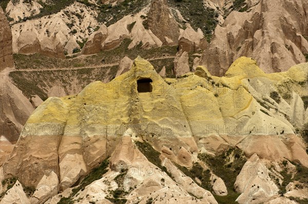 Green-yellow mineral deposits in weathered tuff formations