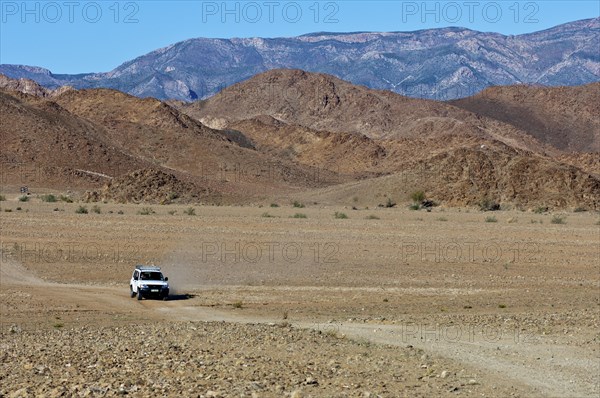 Mitsubishi SUV on a dirt road