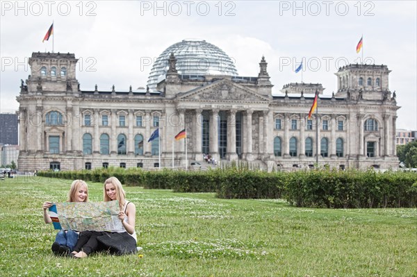 Two young women studying a map of Berlin