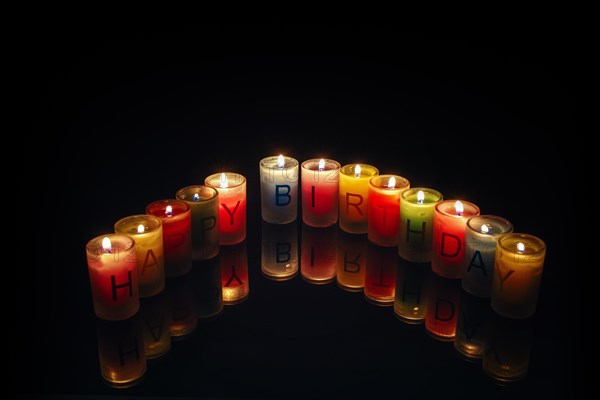 Birthday candles with letters forming the words 'Happy Birthday'