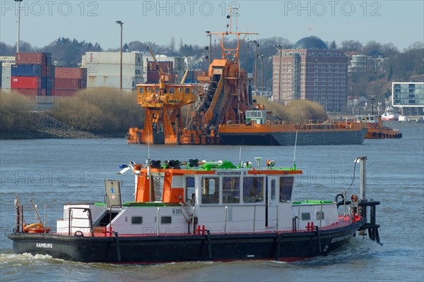 Monitoring vessel 'Deepenschriewer' in front of a bucket-chain dredger