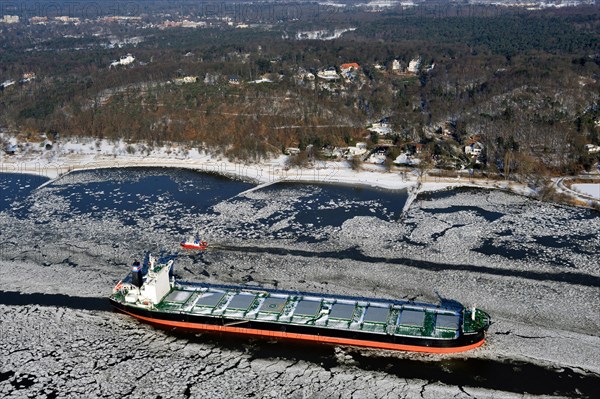 Ship on the Elbe River with ice flow