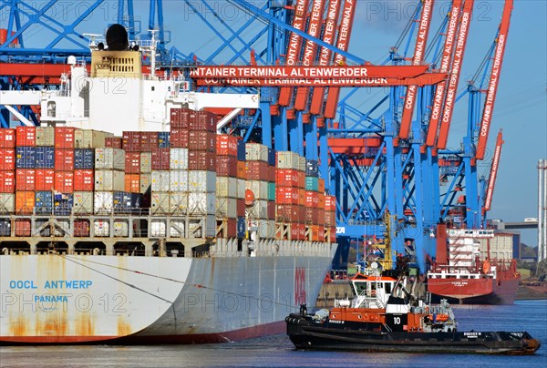 Container ship OOCL Antwerp of the OOLC shipping company with the tug Bugsier 10