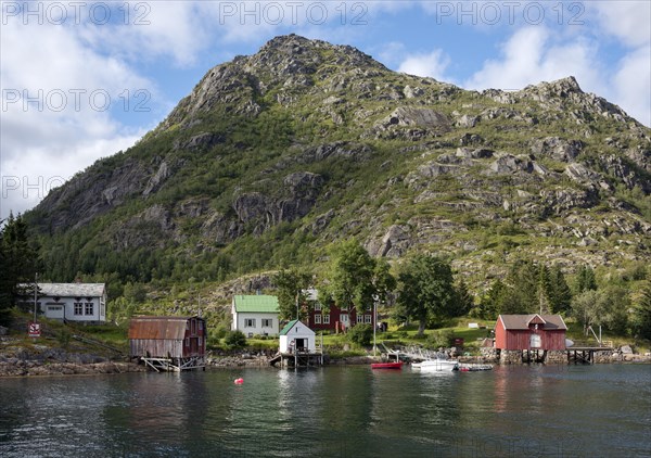 Colourful wooden houses on the shore with a jetty