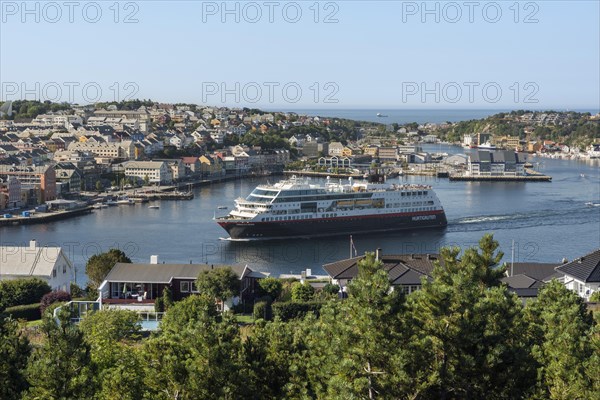 Cityscape with the harbour as a cruise ship is departing