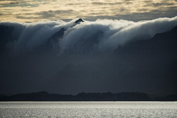 Clouds rolling over mountains