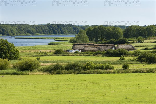 Thatched cottages beside a lake