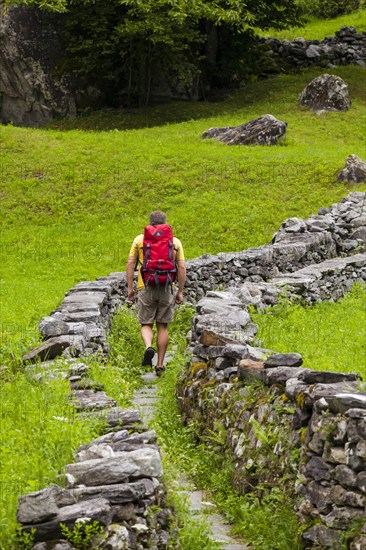 A man hiking along a Mulattiera near Sabbione