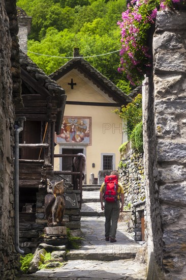 A man hiking in the village of Foroglio