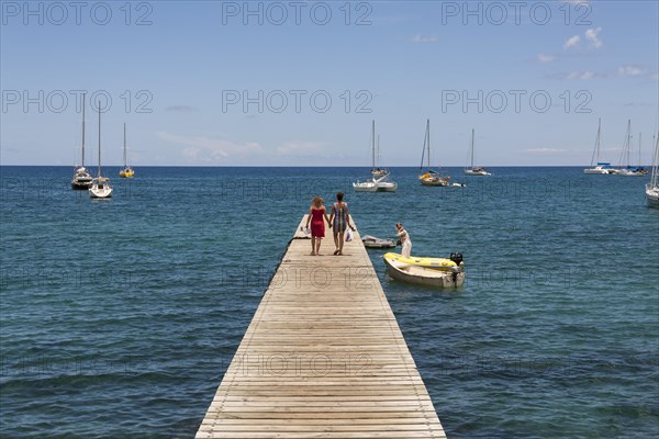 Two people walking on a jetty