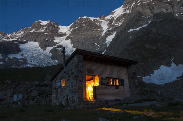 Schmadrihuette mountain hut illuminated at dusk