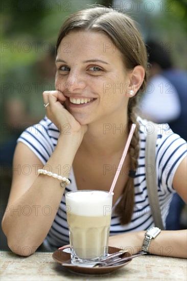 Young woman with a latte macchiato