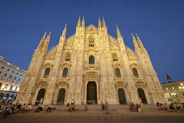 Tourists in front of the west facade of Milan Cathedral or Duomo di Santa Maria Nascente