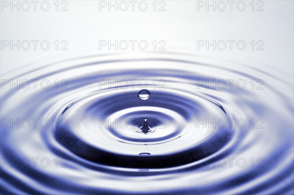 Water droplets falling onto water surface