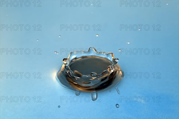 Water droplets falling onto water surface