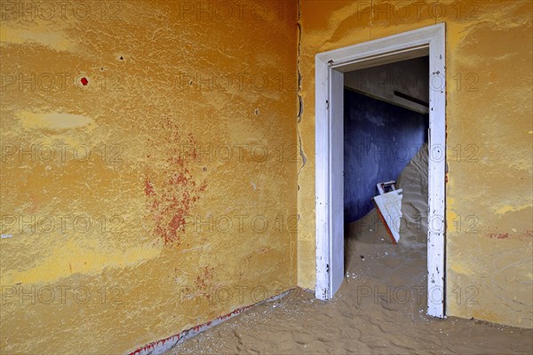 Building taken over by sand from the desert