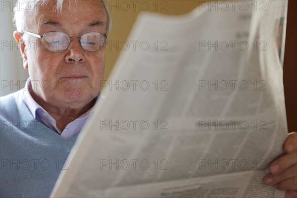 Senior citizen reading a newspaper