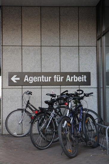 Bicycles parked in front of the sign 'Agentur fuer Arbeit'