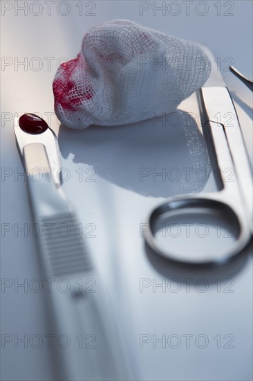 Scalpel and blood on a cotton swab