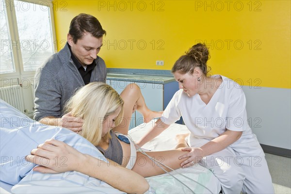 Midwife caring for a pregnant woman during labour