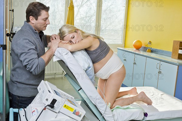 Man and woman in the delivery room during childbirth