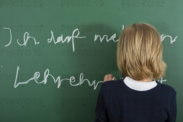 Schoolboy writing on the blackboard as a penalty