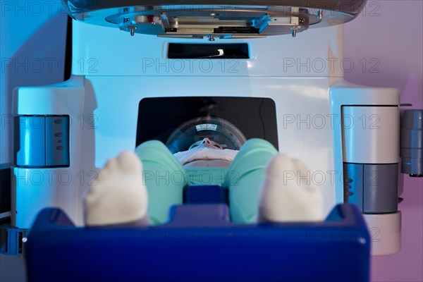 Patient lying in a linear particle accelerator for radiation treatment