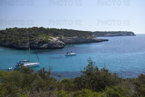 Sailing boats in the Calo d'en Garrot bay