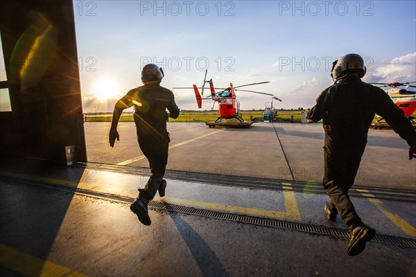 Pilots sprinting towards a helicopter