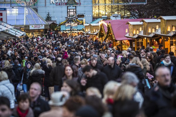 Crowds thronging between stores and Christmas market stalls
